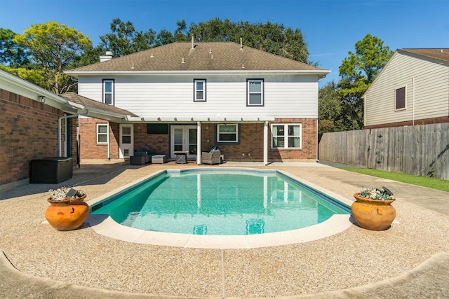 view of swimming pool with a patio area and french doors