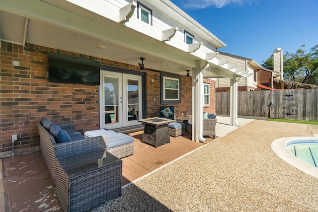 view of patio / terrace with french doors and a fire pit