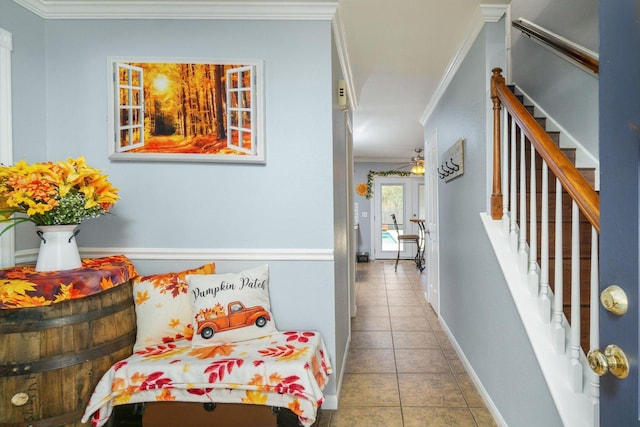 living area with tile patterned floors, ornamental molding, and ceiling fan