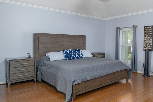 bedroom with crown molding and wood-type flooring