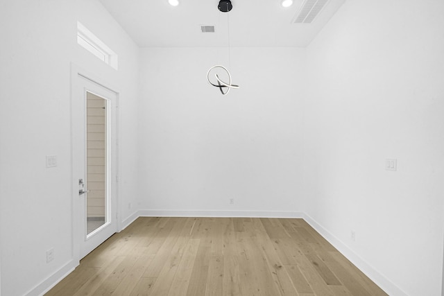 empty room with light hardwood / wood-style flooring