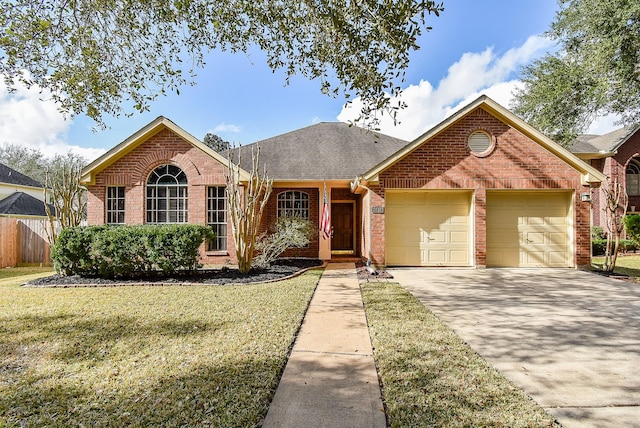 view of front of property with a front yard and a garage