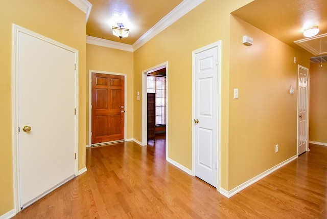 entrance foyer featuring light hardwood / wood-style flooring and ornamental molding