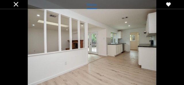 kitchen with white cabinets and light hardwood / wood-style floors