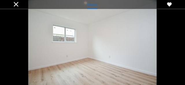 empty room with light hardwood / wood-style floors