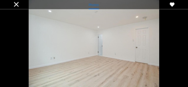 unfurnished room with light hardwood / wood-style floors