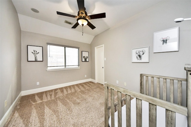 unfurnished bedroom featuring lofted ceiling, visible vents, carpet flooring, ceiling fan, and baseboards