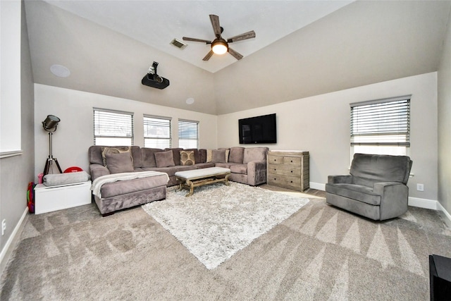 living area featuring visible vents, a ceiling fan, carpet flooring, vaulted ceiling, and baseboards