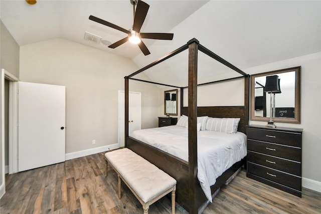 bedroom featuring lofted ceiling, baseboards, visible vents, and wood finished floors