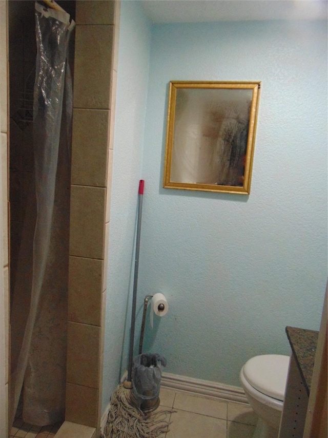 bathroom featuring a shower with shower curtain, tile patterned flooring, vanity, and toilet