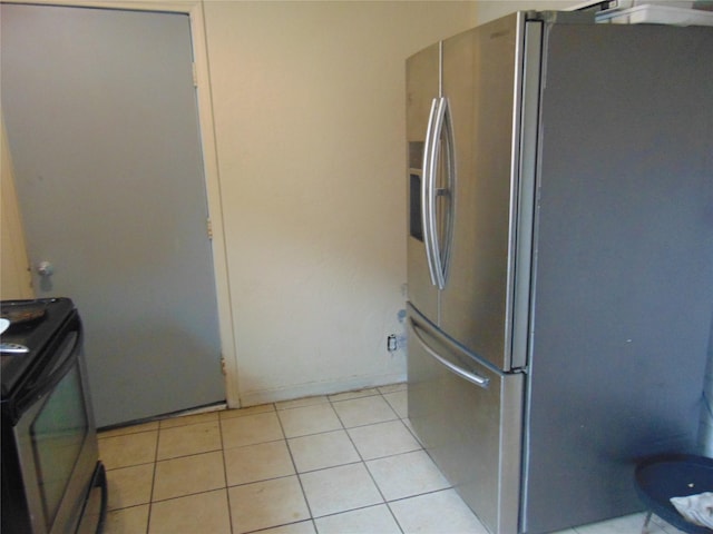 kitchen with appliances with stainless steel finishes and light tile patterned floors