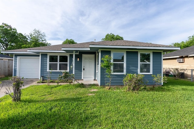 view of front of house featuring a front yard and a garage