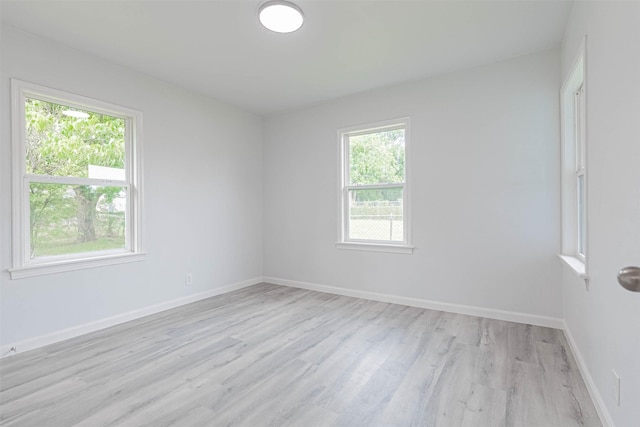 empty room with light hardwood / wood-style flooring