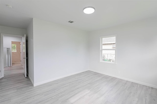 empty room with light hardwood / wood-style flooring