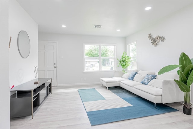 living room with light hardwood / wood-style flooring