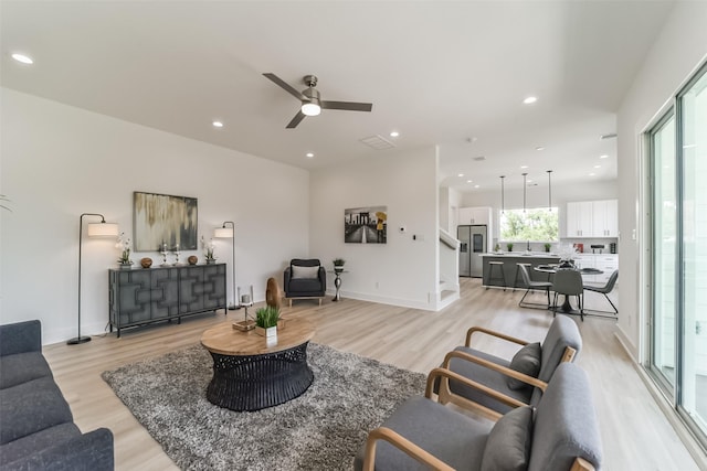 515 Egan St, Houston, TX 77020 - living room with light wood-style flooring, recessed lighting, ceiling fan, and baseboards