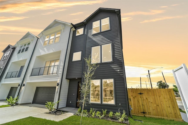 view of front of home with a garage and a balcony