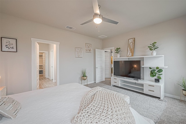 bedroom with light carpet and ceiling fan