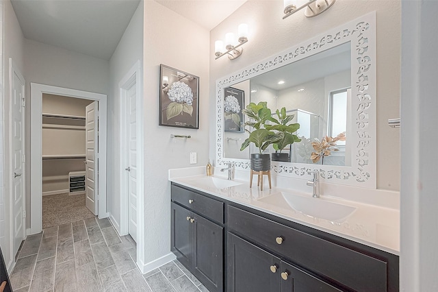 bathroom with vanity and a shower with door