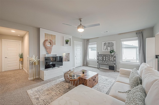 carpeted living room featuring ceiling fan