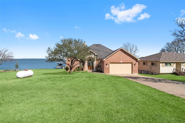 81 Paradise Trl, Coldspring, TX 77331 - view of front facade with a garage, brick siding, a water view, a front yard, and concrete driveway