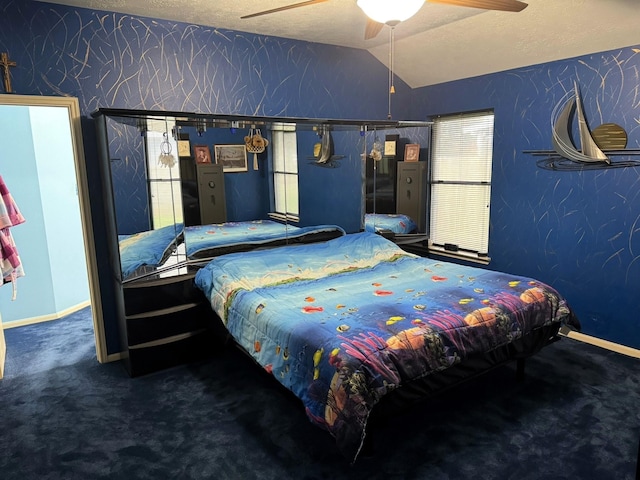 carpeted bedroom with ceiling fan, a textured ceiling, and lofted ceiling