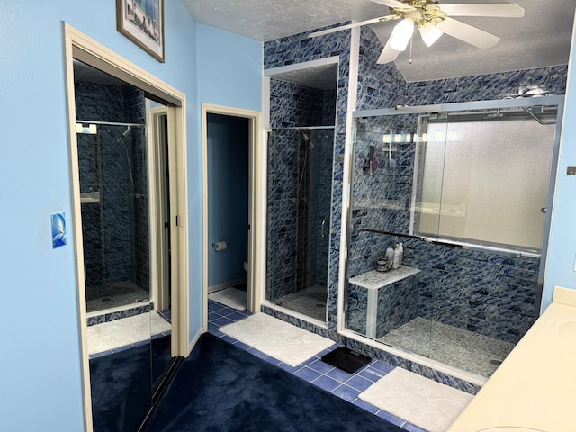 bathroom featuring tile patterned flooring, an enclosed shower, and a textured ceiling