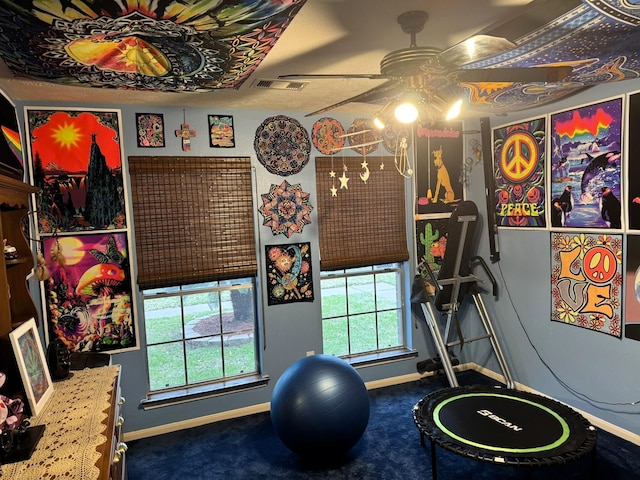 exercise room with carpet floors and ceiling fan