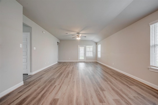 empty room featuring light wood-type flooring, lofted ceiling, and ceiling fan