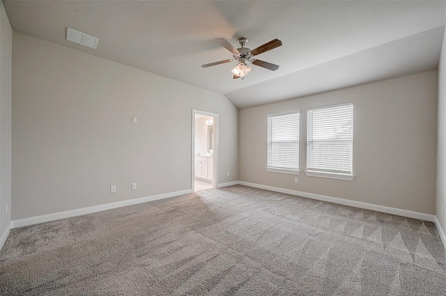 carpeted empty room featuring vaulted ceiling and ceiling fan