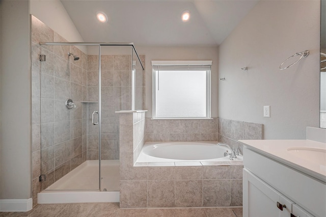 bathroom featuring lofted ceiling, plus walk in shower, and vanity