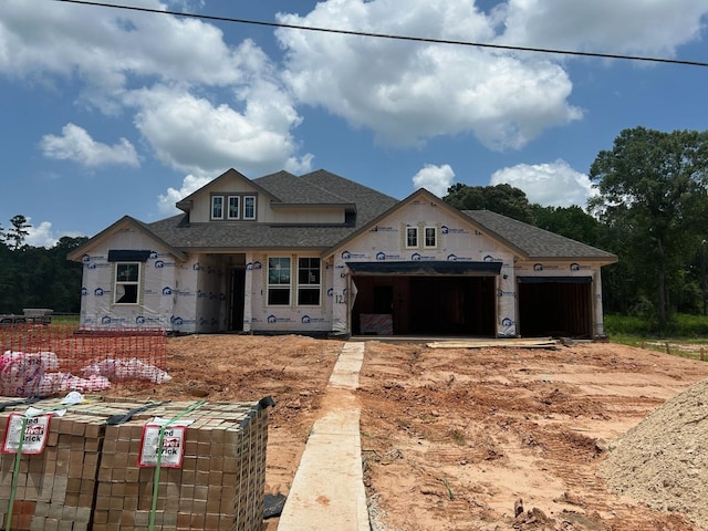 126 Luther Dean Ln, New Waverly, TX 77358 - property in mid-construction featuring roof with shingles, an attached garage, and driveway