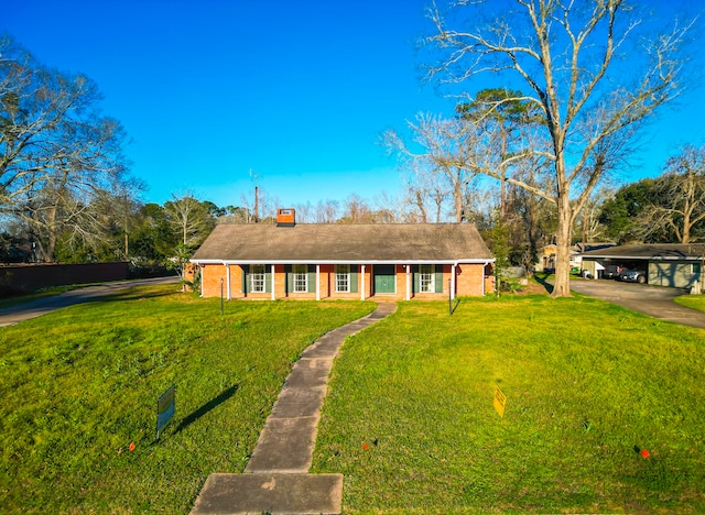 single story home featuring a carport and a front yard