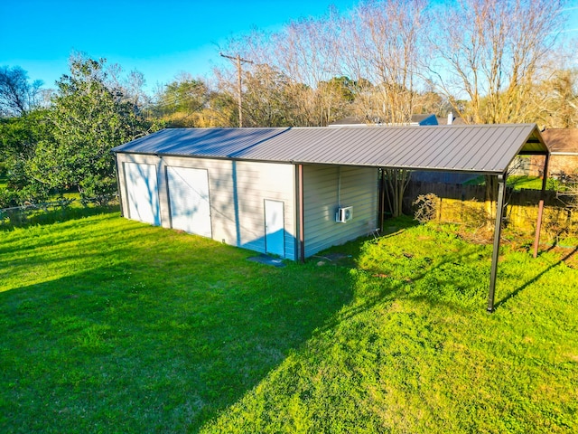 view of outbuilding with a lawn and a carport