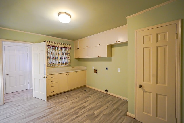 laundry area with cabinets, light hardwood / wood-style flooring, hookup for a washing machine, ornamental molding, and electric dryer hookup