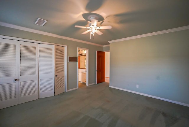 unfurnished bedroom featuring ceiling fan, dark colored carpet, crown molding, and a closet