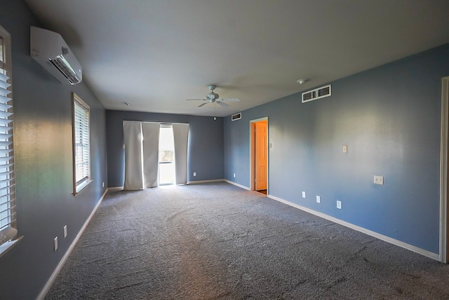 carpeted empty room with ceiling fan and an AC wall unit