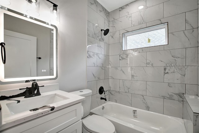 full bathroom featuring tiled shower / bath combo, vanity, and toilet