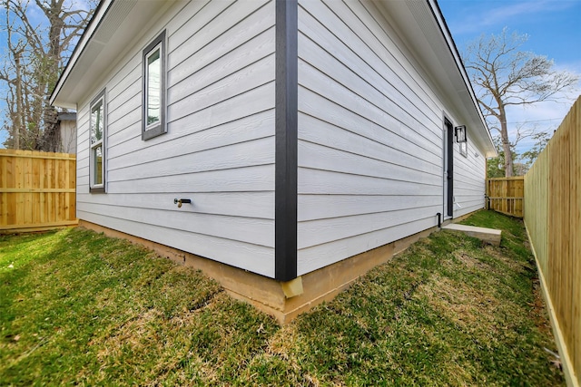 view of side of home featuring a lawn