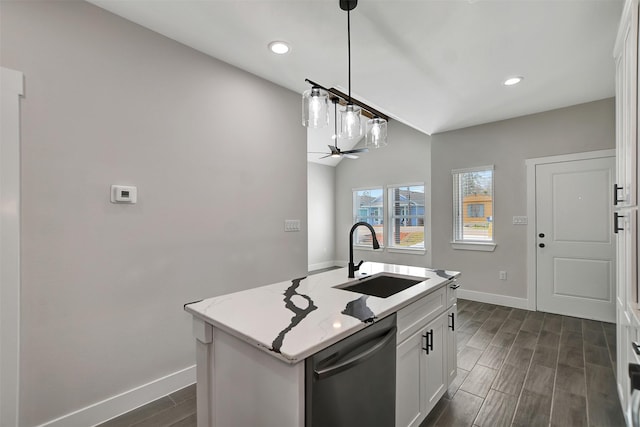 kitchen with a center island with sink, hanging light fixtures, white cabinets, sink, and black dishwasher