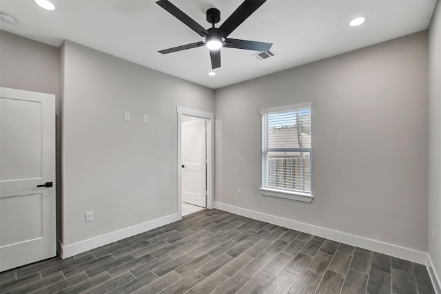 empty room featuring ceiling fan and dark hardwood / wood-style floors