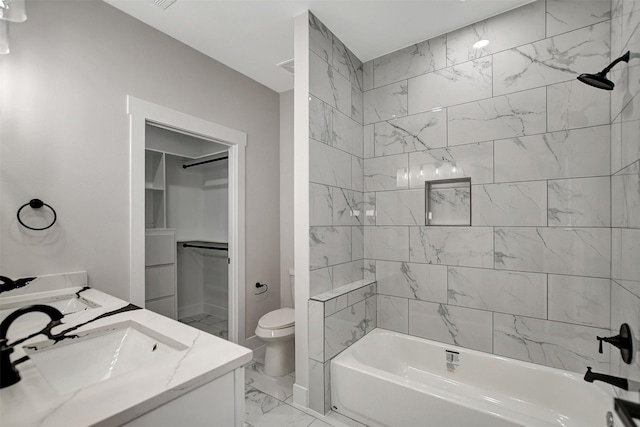 full bathroom featuring tiled shower / bath combo, toilet, and vanity