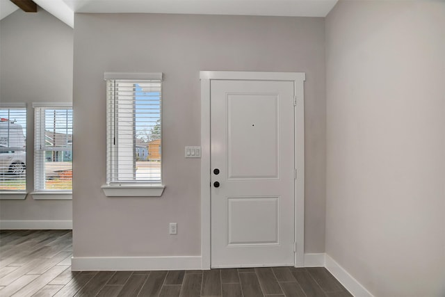 entryway featuring lofted ceiling with beams