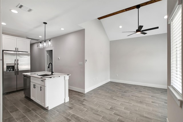 kitchen with white cabinets, an island with sink, pendant lighting, and stainless steel appliances