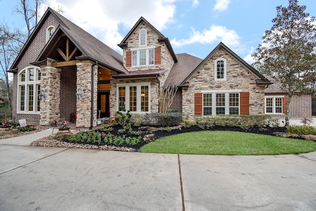 view of front of home with stone siding and a front yard