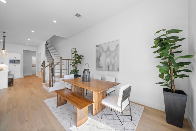 dining area with baseboards, visible vents, stairs, light wood-style floors, and recessed lighting