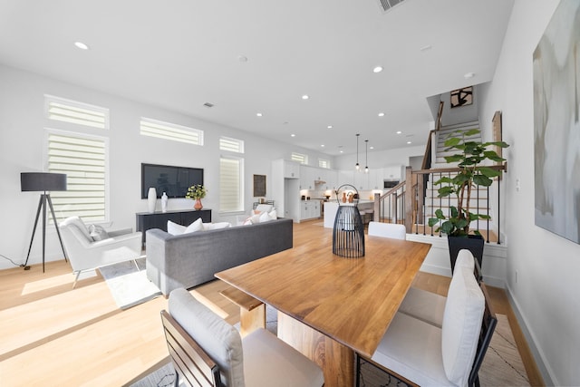 dining space featuring recessed lighting, visible vents, baseboards, light wood-style floors, and stairway