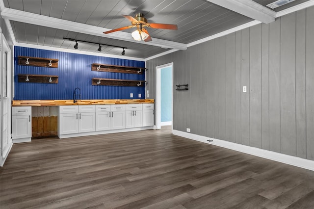 bar with butcher block counters, white cabinets, dark hardwood / wood-style flooring, beamed ceiling, and sink