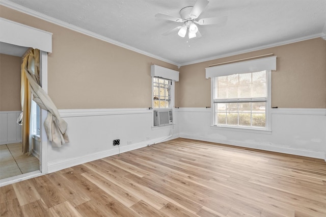 spare room featuring light hardwood / wood-style floors, ceiling fan, and ornamental molding