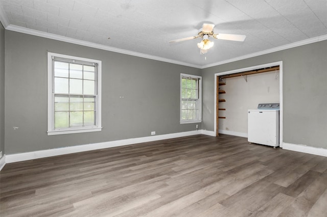 interior space with crown molding, wood-type flooring, washer and clothes dryer, and ceiling fan